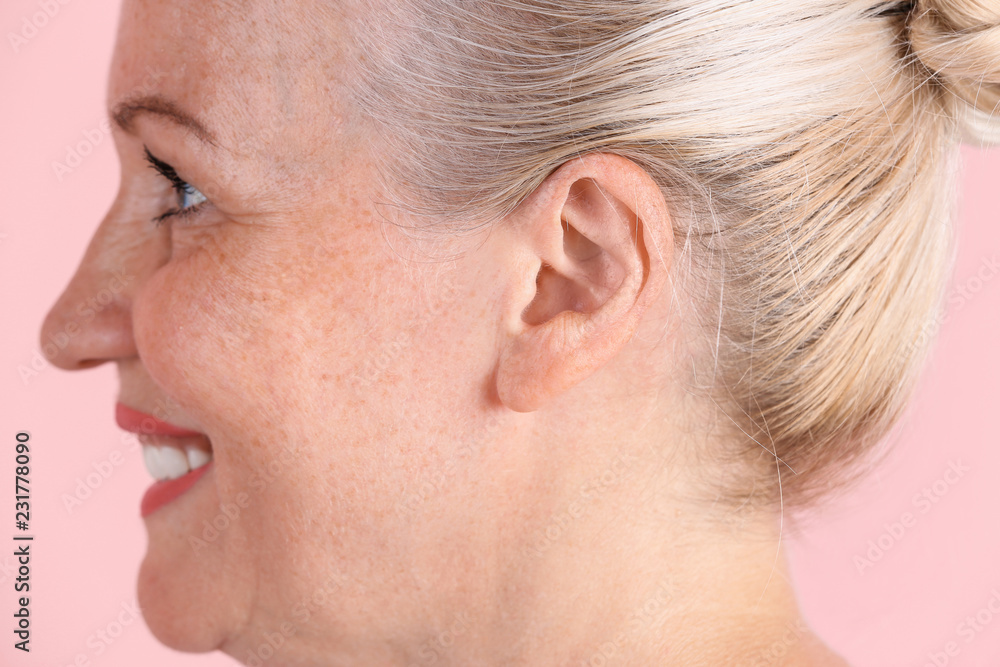 Mature woman on color background, closeup. Hearing problem Mature woman on color background, closeup. Hearing problem