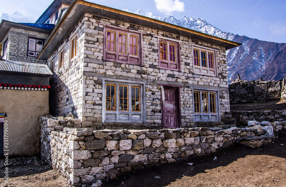 Close up view of rural stone house in Nepal mountain area. Purple door and windows. Sagarmatha (Everest) National Park, Nepal.