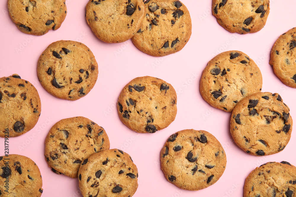 Delicious chocolate chip cookies on color background, flat lay Delicious chocolate chip cookies on color background, flat lay