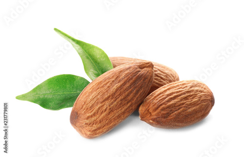 Organic almond nuts and leaves on white background. Healthy snack