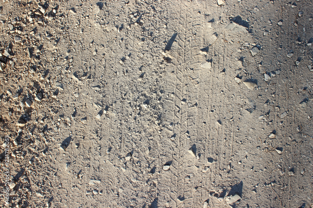 Traces markings and stones on dirt road background shadows Traces markings and stones on dirt road background shadows