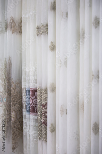 Beautiful thin curtains texture, transparent tulle, examples in the store