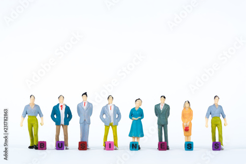 BUSINESS text and Group or figure miniature businessman of small people investor and office worker secretary on white background for money and financial business concept.