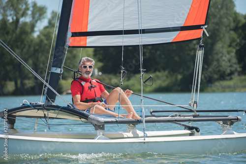 mature man enjoying sailing on a lake