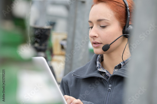 busy businesswoman on the phone checking tablet photo