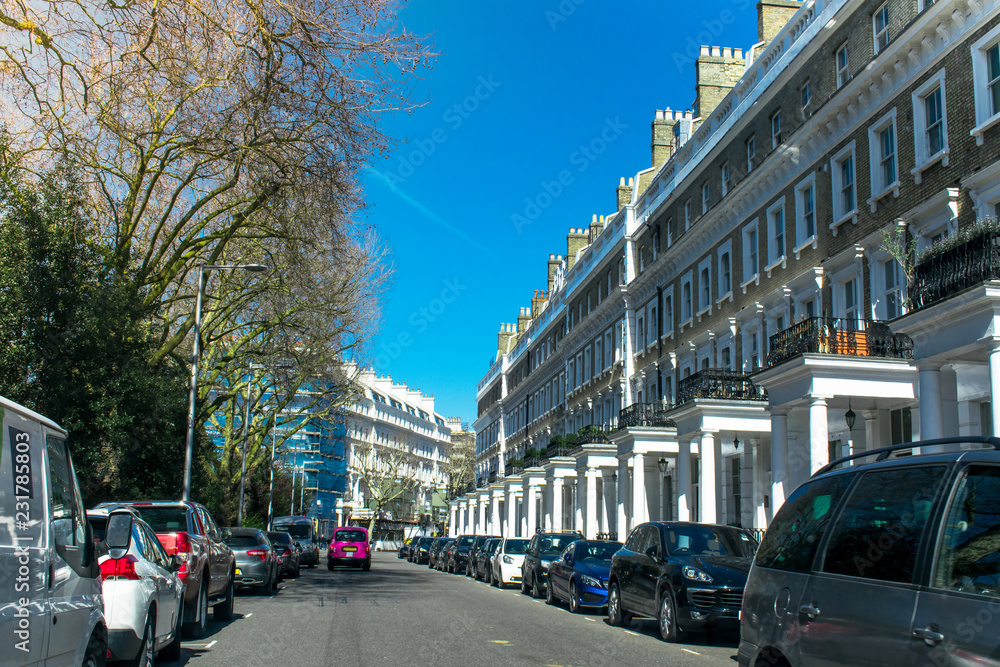 Wide view of Row of Typical old Britain Houses in London UK with cars on street