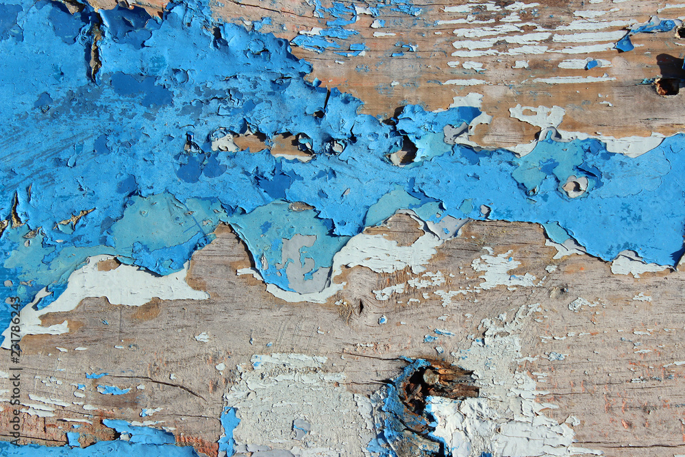 Peeling cracked old blue paint on wood plank texture surface detail close up horizontal abstract composition