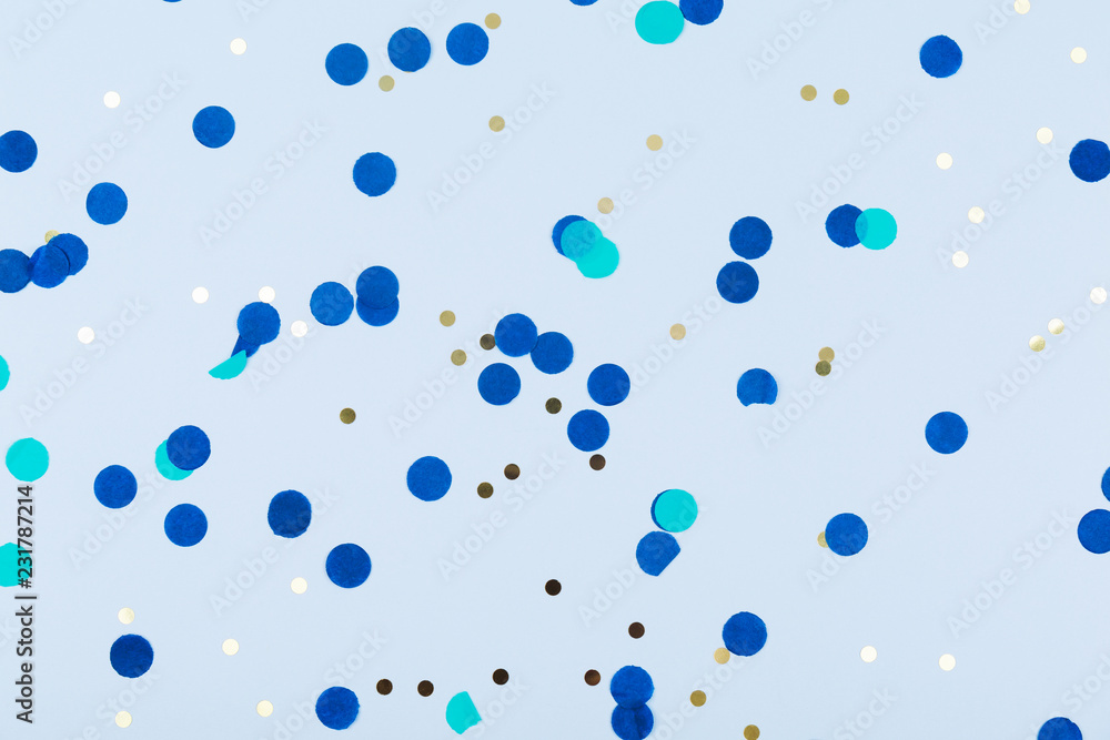 Blue background with gold and dark blue confetti. Christmas and Hanukkah, holiday concept.