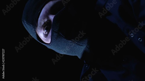 Pov of victim, criminal in balaclava closing mouth and trying to strangle person