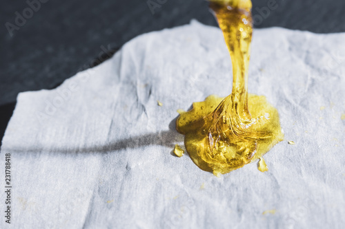 Half gram of THC concentrated rosin dripping on wax paper