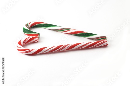 Christmas Candy cane with red and green Bow isolated.