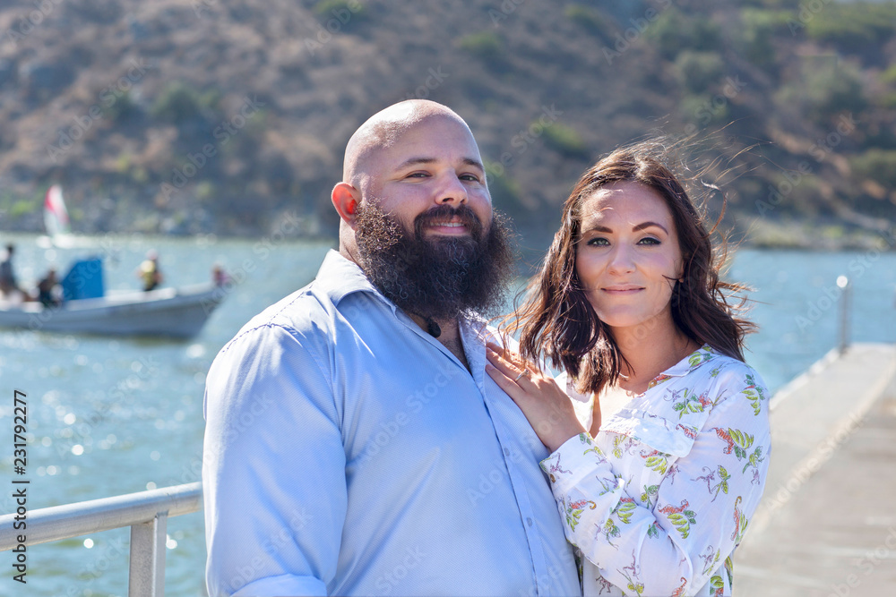 Couple at the Lake in front of a Small Boat