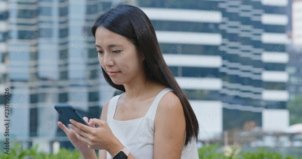 Woman use of smart phone in city Woman use of smart phone in city