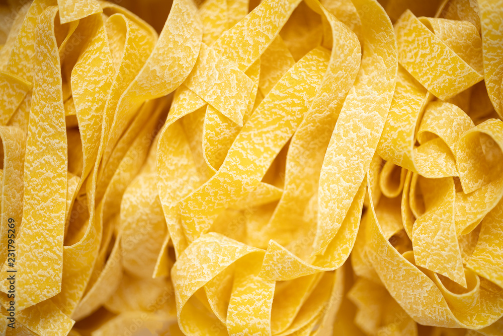 uncooked italian pappardelle pasta blur defocused