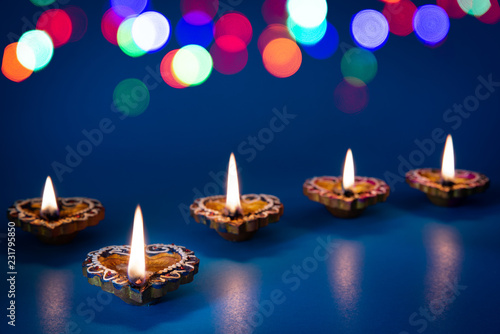 Happy Diwali - Clay Diya lamps lit during Dipavali  Hindu festival of lights celebration