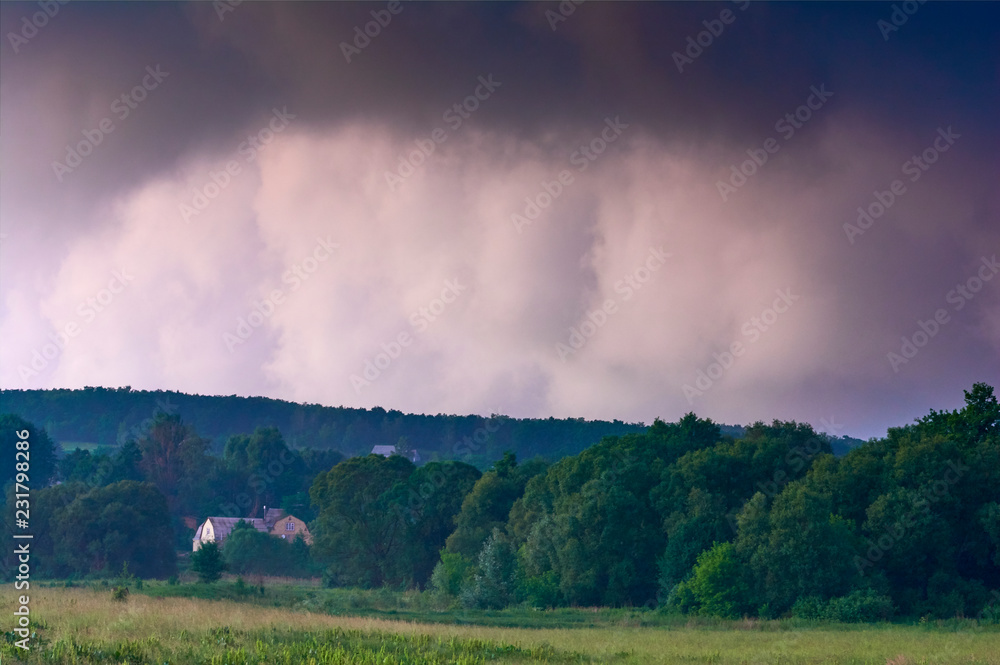 Thunderclouds against the clear evening sky. Dramatic condition in nature. Summer time in Ukraine. Thunderclouds against the clear evening sky. Dramatic condition in nature. Summer time in Ukraine.