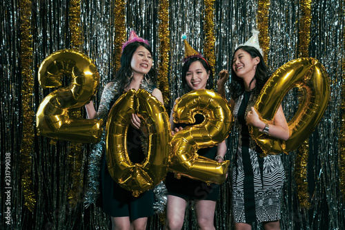 ladies with birthday hats at new year eve party photo