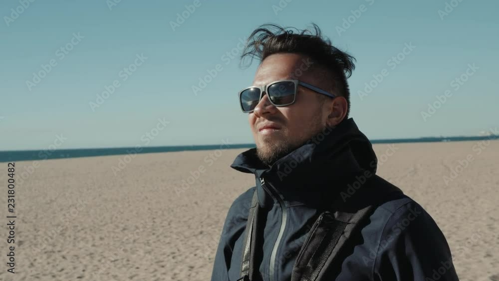 Handsome man with sunglasses in the Middle of the desert student tourist wind Handsome man with sunglasses in the Middle of the desert student tourist wind