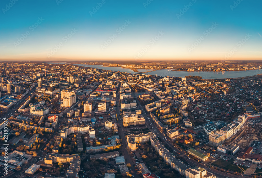 Foto Stock Aerial drone shot of modern city downtown with buildings from  above, streets with cars in sunset | Adobe Stock