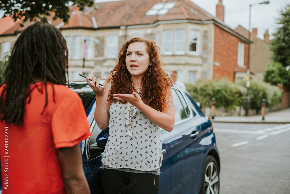 Women arguing after a car accident