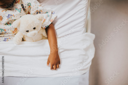 Little girl sleeping in a hospital bed