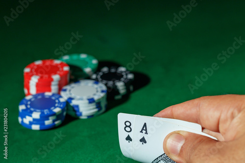 Casino games concept,Poker chips on gamble table , Light through background, winning hands of cards. gambling success