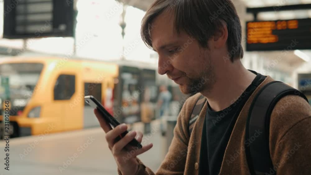 Man voice recognition with smart phone in subway underground railway station train public transportation tourist walking student traveller Man voice recognition with smart phone in subway underground railway station train public transportation tourist walking student traveller