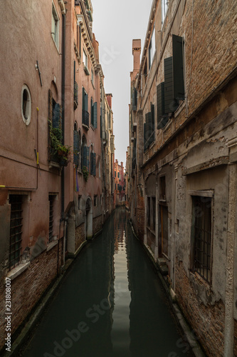 View on tight canal in Venice with beautiful architecture