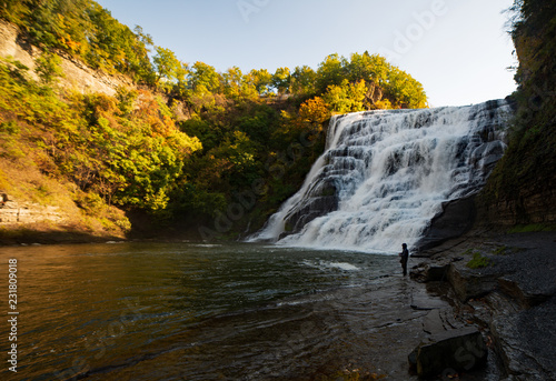 Ithaca falls near Cornell University  autumn colors  fly fisherman at the waterfall