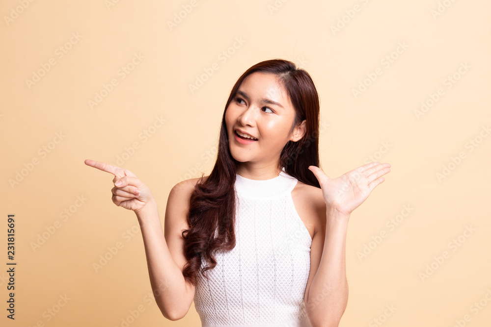 Excited Asian woman point to blank space. Excited Asian woman point to blank space.