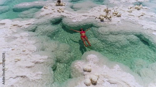 woman floating in the Dead Sea salt