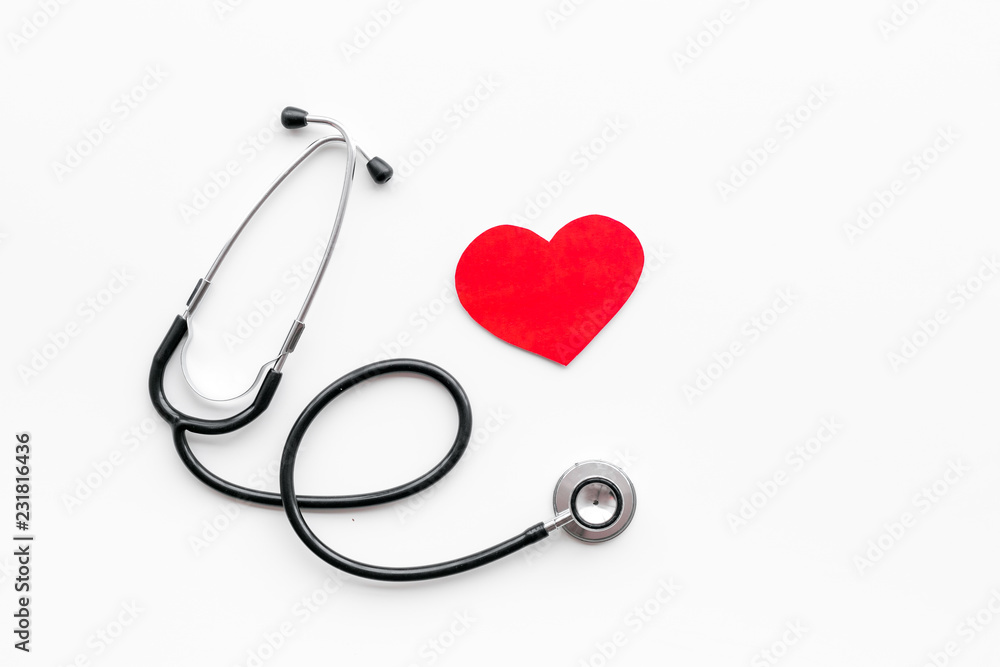 Heart disease concept. Stethoscope near heart sign on white background top view copy space Heart disease concept. Stethoscope near heart sign on white background top view copy space
