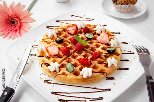 waffles with berries and chocolate syrup