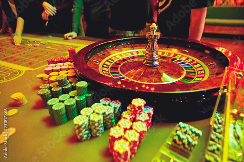 Gambling with colorful spinning fortune roulette wheel in casino