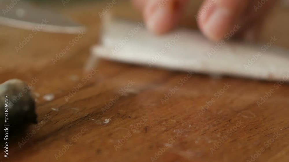 Chef hands prepare raw fish over cutting board. Closeup. Woman cooking raw frozen fish on kitchen Chef hands prepare raw fish over cutting board. Closeup. Woman cooking raw frozen fish on kitchen