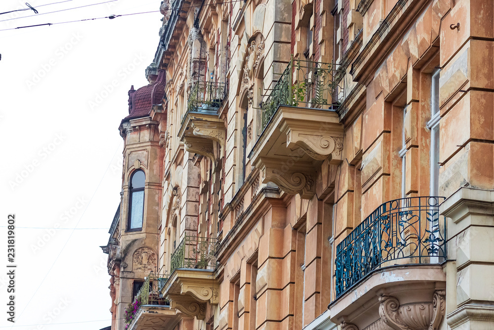 The facade of an old building with decorative elements in a modern European city_