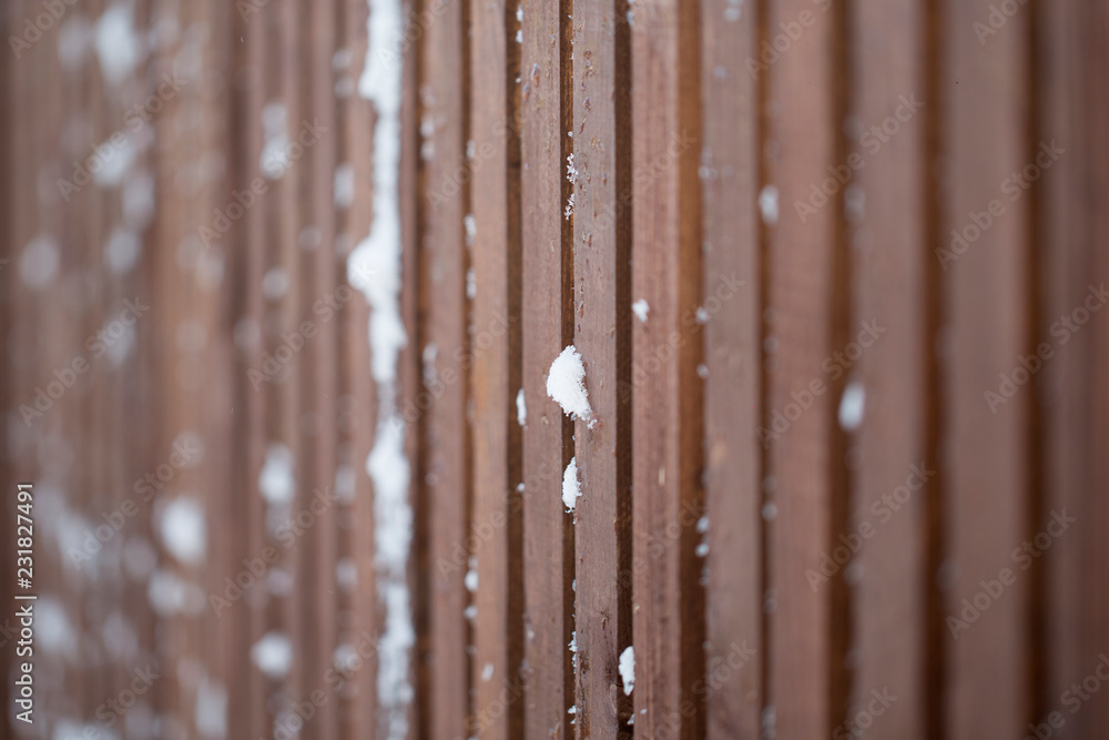 snow on a wooden fence as a background image snow on a wooden fence as a background image