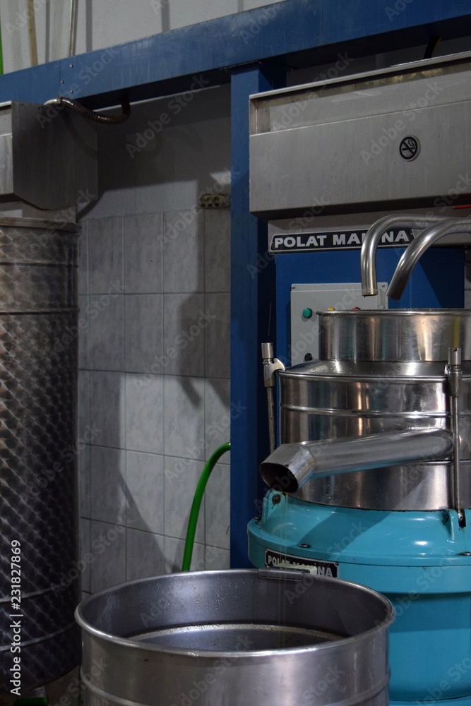 Olive oil squeeze.The process of extraction of olive oil of the first extraction at the plant obtained from olives, the last phase, separated by water with the help of machines, comes out with pure, t Olive oil squeeze.The process of extraction of olive oil of the first extraction at the plant obtained from olives, the last phase, separated by water with the help of machines, comes out with pure, t