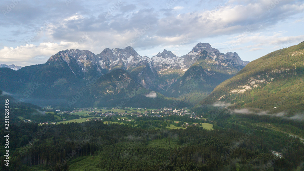 Fototapeta premium Aerial view of mountain range with snow in the alpine mountains