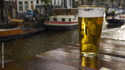 Photography Close up of a beer by the side of an Amsterdam canal.