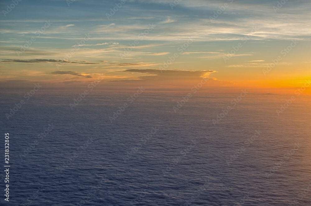 atmospheric mood above the clouds at sunset