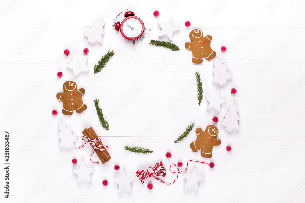 Christmas composition. Round frame made of  decorations, fir tree branches, gingerbread man cookies on white background. Winter holidays concept. Flat lay, top view, copy space