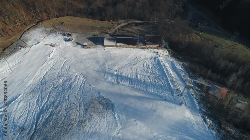 Aerial shot: The snow cannon's makes artificial snow on the slope. Winter sports Aerial shot: The snow cannon's makes artificial snow on the slope. Winter sports