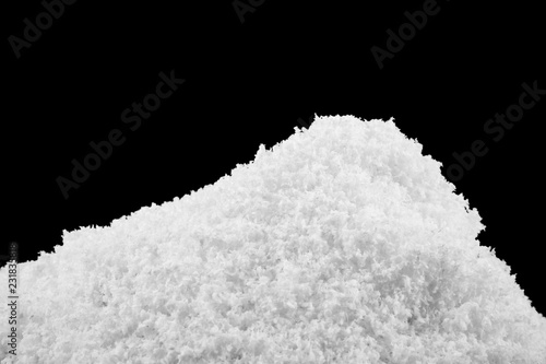 heap of white snow isolated on black background
