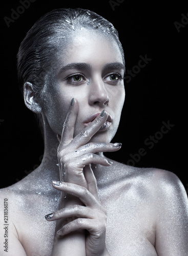 Beauty portrait of young gorgeous woman. Female with hand near face  on black background