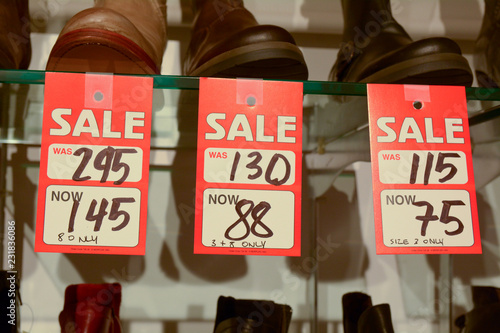 Sale sign in womens shoe store - with before and after sale prices photo