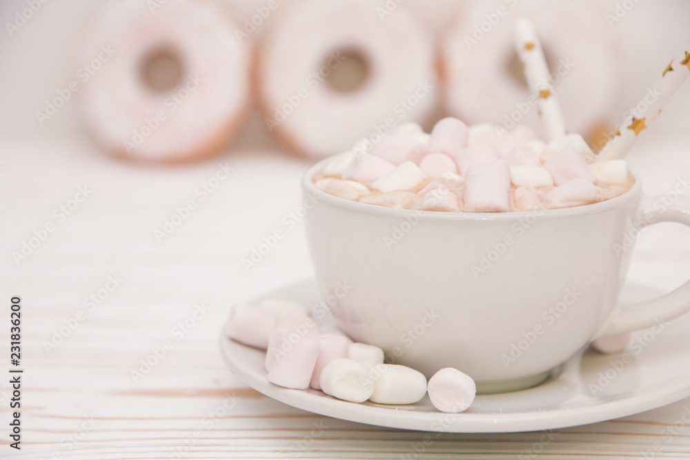 hot chocolate with marshmallow candy and Christmas decorations on white wooden background hot chocolate with marshmallow candy and Christmas decorations on white wooden background