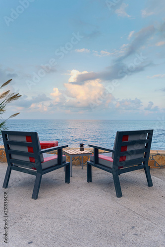 a fragment of a cafe on the coast against the background of the sea and sky © westermak15