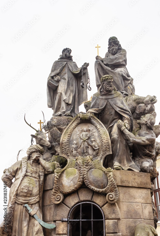 Statues of Saints John of Matha, Felix of Valois, and Ivan on Charles Bridge in Prague, Czech Republic Statues of Saints John of Matha, Felix of Valois, and Ivan on Charles Bridge in Prague, Czech Republic