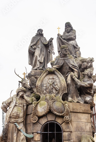 Statues of Saints John of Matha, Felix of Valois, and Ivan on Charles Bridge in Prague, Czech Republic photo